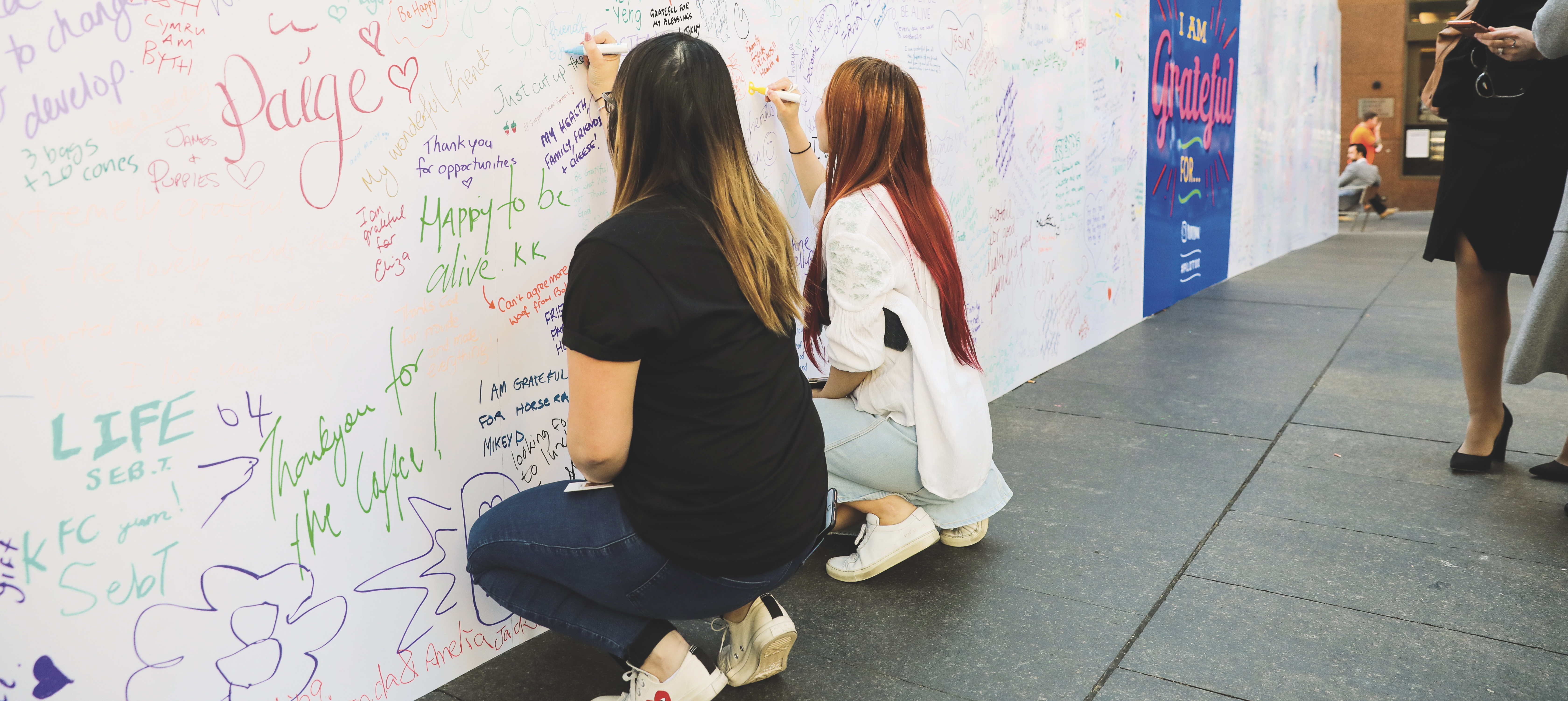 Members of the public write notes of gratitude at a Pilot Pen event in Sydney.